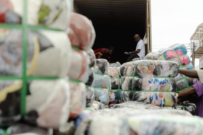 Secondhand clothing bales being offloaded off the shipping trucks at the Importers yard in the Kantamanto Market